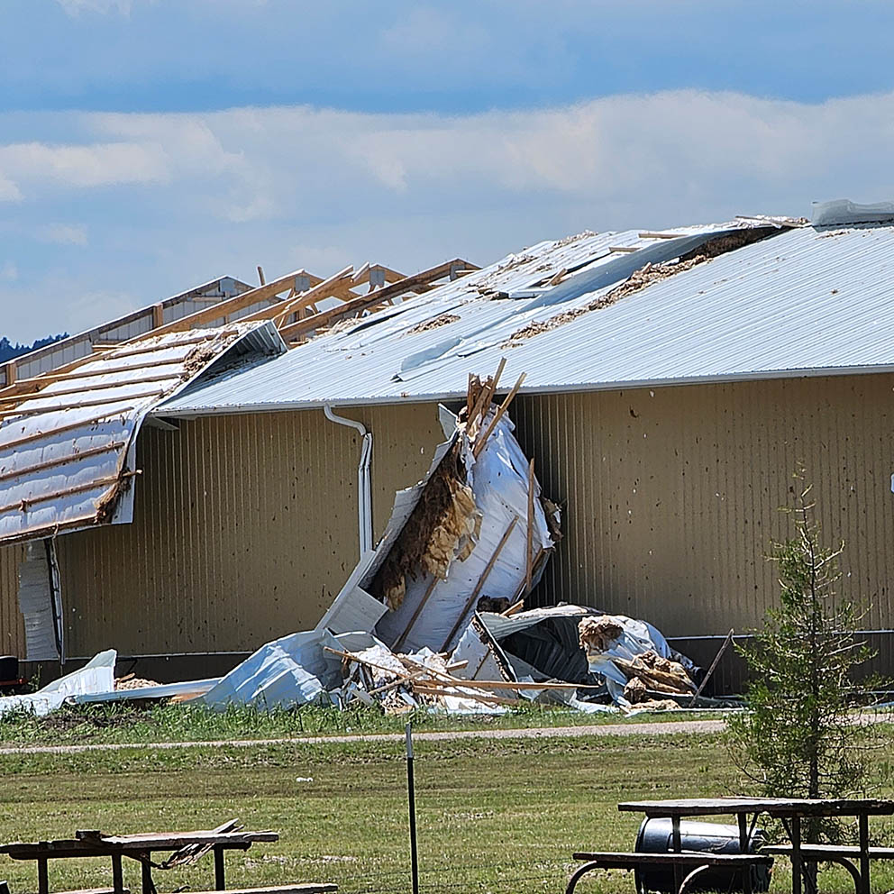 Photo of a storm damaged roof.